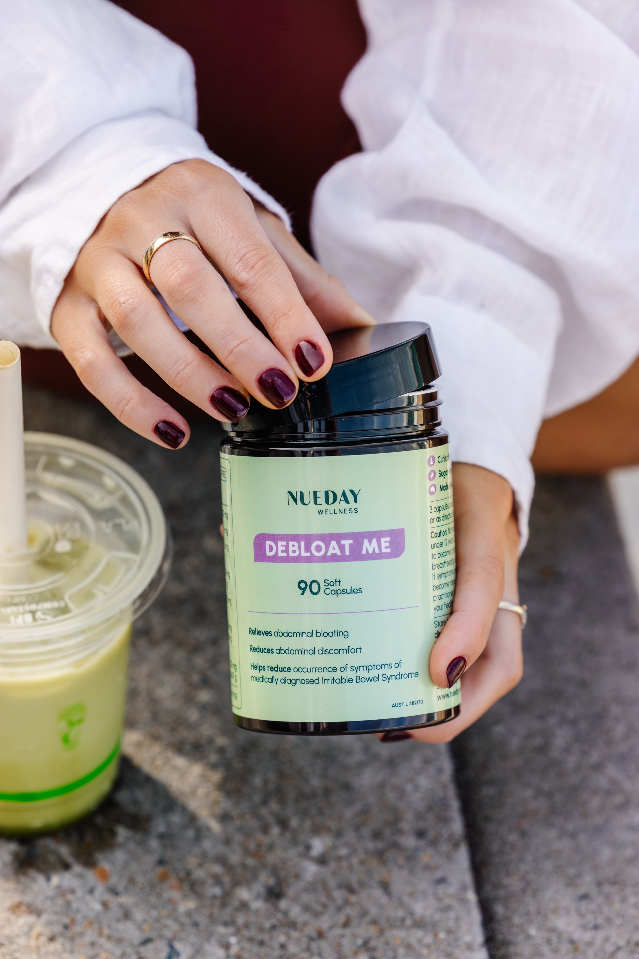 Front view of a Nueday Wellness supplement jar labeled “Debloat Me,” a daily gut health support supplement designed to relieve bloating and support digestion. 